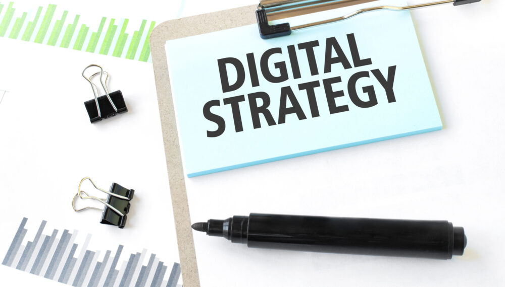 Paper plate, marker, diagram, chart and office tools. Text DIGITAL STRATEGY